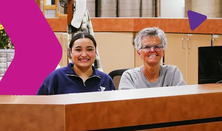 YMCA front desk staff members smiling at the camera