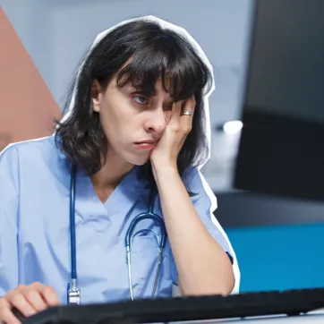 tired nurse using the computer