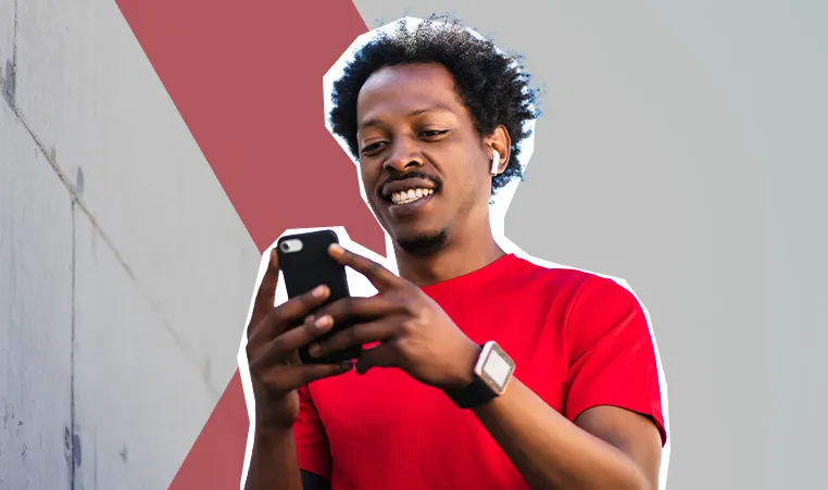 man in athletic clothing texting on phone